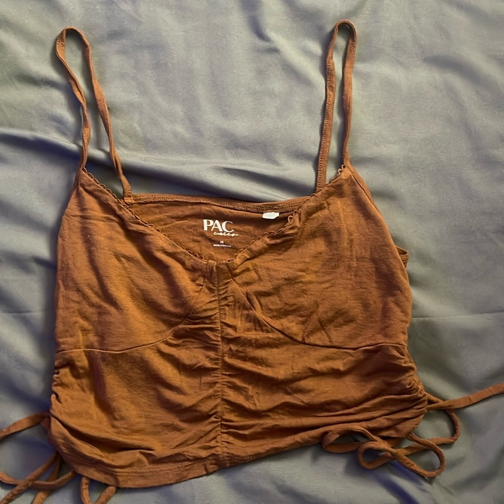 brown tank with a ruffle tie on each side.
